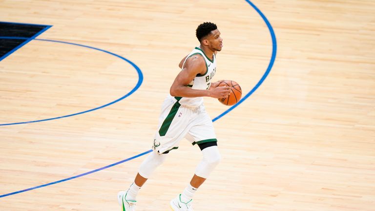 Giannis Antetokounmpo top-scored with 32 points as Milwaukee edged out Philadelphia in overtime.