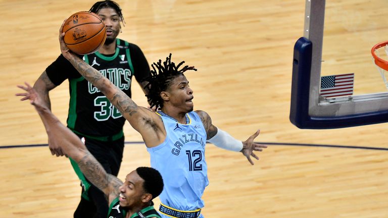 Memphis Grizzlies guard Ja Morant (12) goes up for a dunk against Boston Celtics guard Jeff Teague (55) in the second half of an NBA basketball game Monday, March 22, 2021, in Memphis, Tenn. 