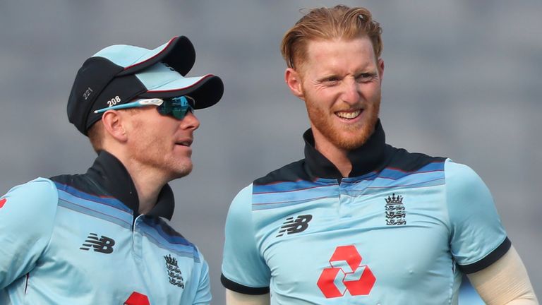 England's Ben Stokes, right, celebrates with captain Eoin Morgan after dismissing India's Shikhar Dhawan during the first One Day International cricket match between India and England at Maharashtra Cricket Association Stadium in Pune, India, Tuesday, March 23, 2021. (AP Photo/Rafiq Maqbool)