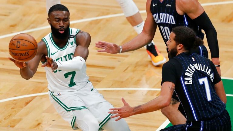 AP - Boston Celtics&#39; Jaylen Brown, left, passes off against Orlando Magic&#39;s Michael Carter-Williams