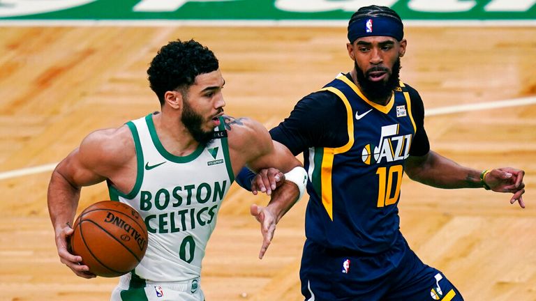 AP - Boston Celtics forward Jayson Tatum (0) drives to the basket against Utah Jazz guard Mike Conley (10)