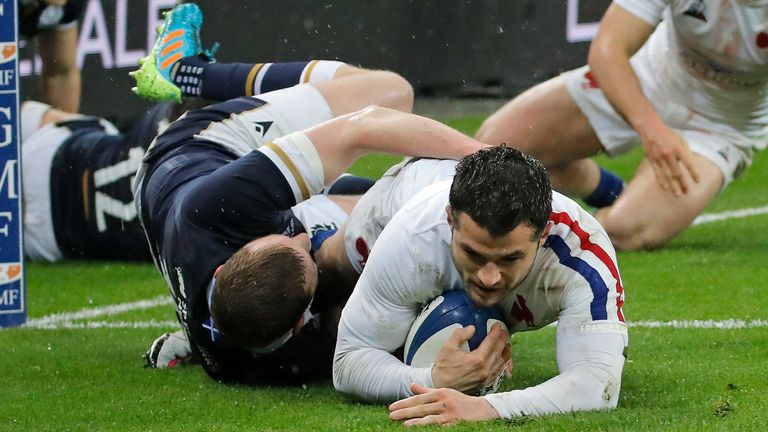 France's Brice Dulin scores the opening try for his team despite the tackle of Scotland's Finn Russell