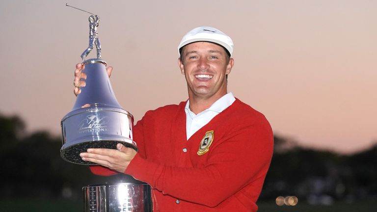 Bryson DeChambeau holds up his championship trophy after winning the Arnold Palmer Invitational golf tournament Sunday, March 7, 2021, in Orlando, Fla. (AP Photo/John Raoux)