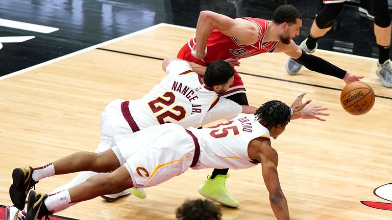 Chicago Bulls guard Zach LaVine battles for a loose ball against Cleveland Cavaliers forwards Larry Nance Jr. and Isaac Okoro