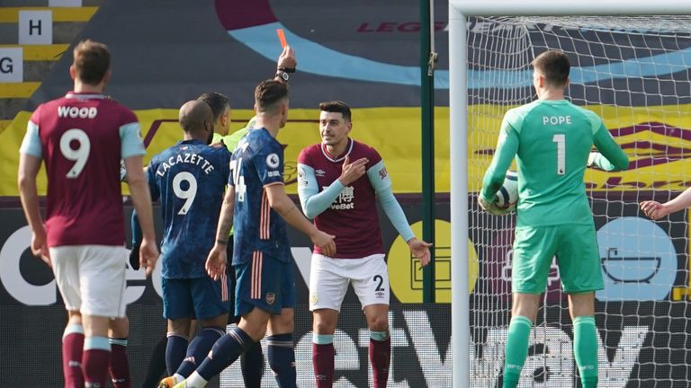 Burnley's Matthew Lowton protests the red card which was given to Erik Pieters before the decision was recinded 