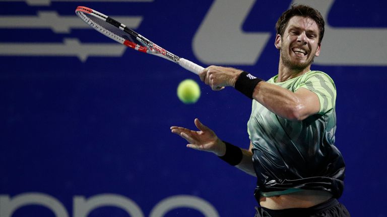 Britain's Cameron Norrie follows through on an forehand to Italy's Fabio Fognini at the Mexican Open tennis tournament in Acapulco, Mexico, Wednesday, March 17, 2021. (AP Photo/Rebecca Blackwell)