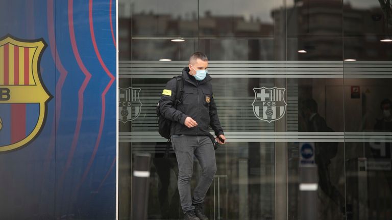 Catalan police leave the Nou Camp offices after the raid on Monday
