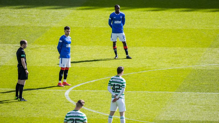 Both sets of players stand together in solidarity against Racism  during the Scottish Premiership match between Celtic and Rangers at Celtic Park