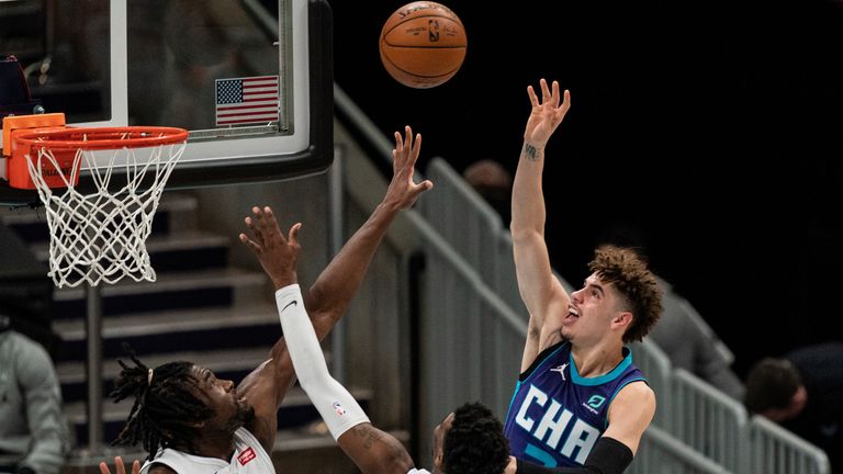 Charlotte Hornets guard LaMelo Ball shoots the ball over Detroit Pistons center Isaiah Stewart and guard Delon Wright