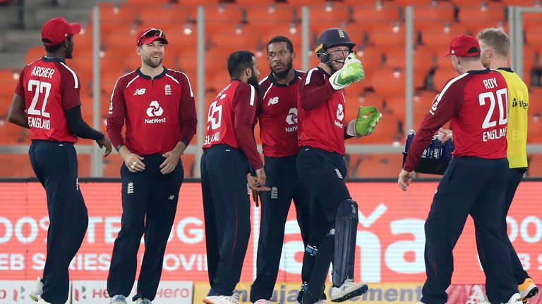 England&#39;s Chris Jordan, center, and teammates celebrate the dismissal of India&#39;s Suryakumar Yadav during the fifth Twenty20 cricket match between India and England at Narendra Modi Stadium in Ahmedabad, India, Saturday, March 20, 2021.