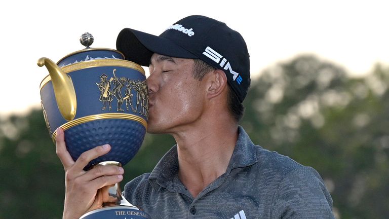 Collin Morikawa kisses the championship trophy after winning the Workday Championship golf tournament Sunday, Feb. 28, 2021, in Bradenton, Fla. (AP Photo/Phelan M. Ebenhack)