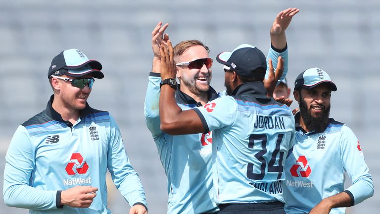 England's Liam Livingstone, second left, celebrates after dismissing KL Rahul during the third ODI between India and England in Pune