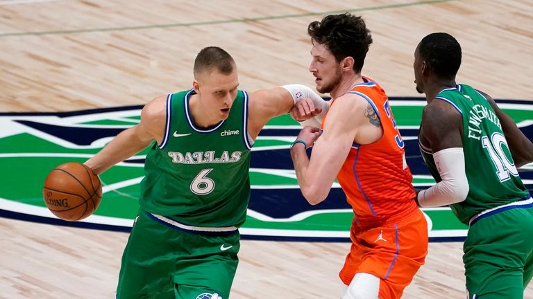 Dallas Mavericks center Kristaps Porzingis works around Oklahoma City Thunder center Mike Muscala