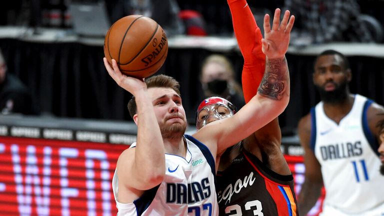 AP - Dallas Mavericks guard Luka Doncic (77) drives to the basket on Portland Trail Blazers forward Robert Covington (23)