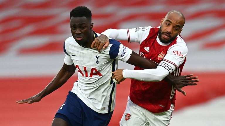 Davinson Sanchez and Alexandre Lacazette compete for possession