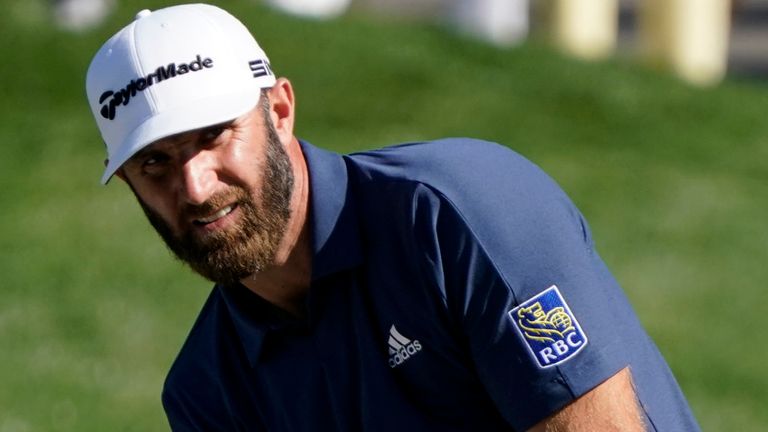 Dustin Johnson chips to the green on the ninth hole during the first round of the The Players Championship golf tournament Thursday, March 11, 2021, in Ponte Vedra Beach, Fla. (AP Photo/John Raoux)