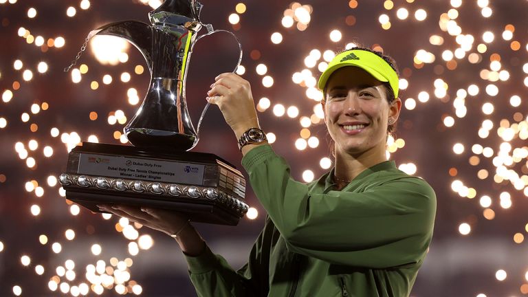 Garbine Muguruza of Spain celebrates with the trophy following victory during the Dubai Duty Free Tennis Women's Final match between Barbora Krejcikova and Garbine Muguruza on Day Seven of the Dubai Duty Free Tennis at Dubai Duty Free Tennis Stadium on March 13, 2021 in Dubai, United Arab Emirates. (Photo by Francois Nel/Getty Images)