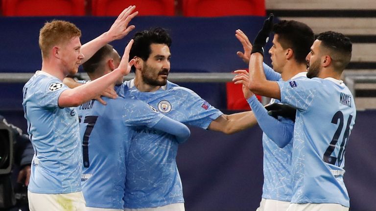 Ilkay Gundogan, centre, is congratulated by Man City team-mates after scoring