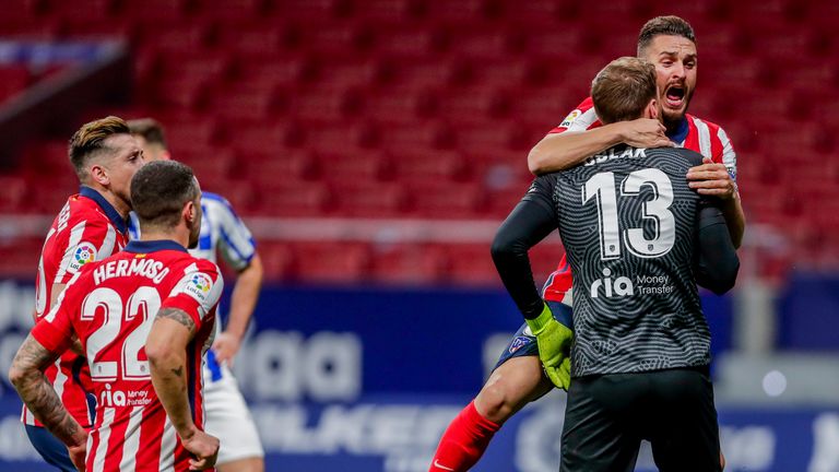 Jan Oblak is mobbed after his late penalty save for Atletico Madrid