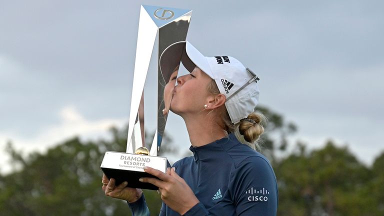 Jessica Korda kisses the championship trophy on the 18th green after winning in a one-hole playoff against Danielle Kang during the final round of the Tournament of Champions LPGA golf tournament, Sunday, Jan. 24, 2021, in Lake Buena Vista, Fla. (AP Photo/Phelan M. Ebenhack) 