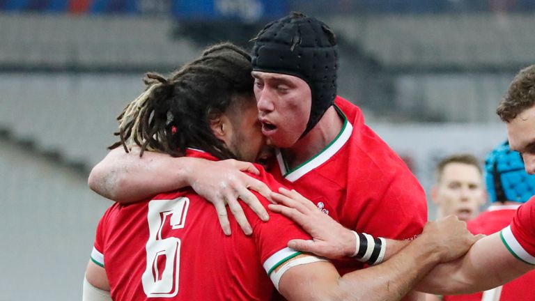 Josh Navidi celebrates with his team-mates after scoring Wales' second try