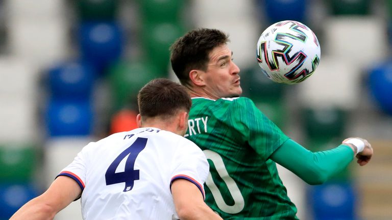 Northern Ireland's Kyle Lafferty jumps for the ball with Matthew Miazga 