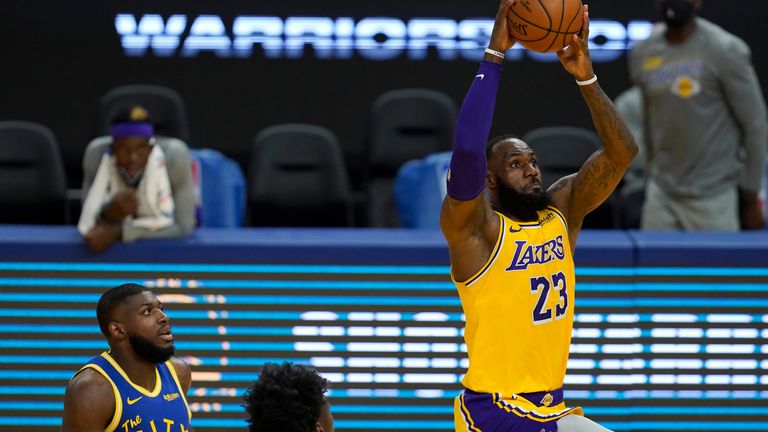 os Angeles Lakers forward LeBron James (23) dunks in front of Golden State Warriors forward Eric Paschall (7) and center James Wiseman during the first half of an NBA basketball game in San Francisco, Monday, March 15, 2021. (