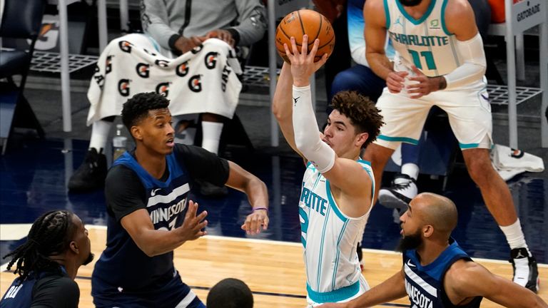 Charlotte Hornets&#39; LaMelo Ball looks to pass as Minnesota Timberwolves&#39; Jarrett Culver and Jordan McLaughlin defend