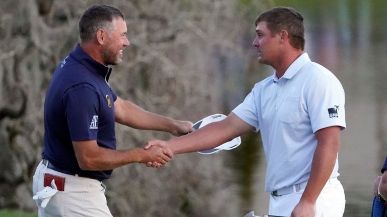 Lee Westwood, of England, and Bryson DeChambeau shake hands after they finished play in the Arnold Palmer Invitational golf tournament Sunday, March 7, 2021, in Orlando, Fla. DeChambeau won the tournament and Westwood finished second. (AP Photo/John Raoux)