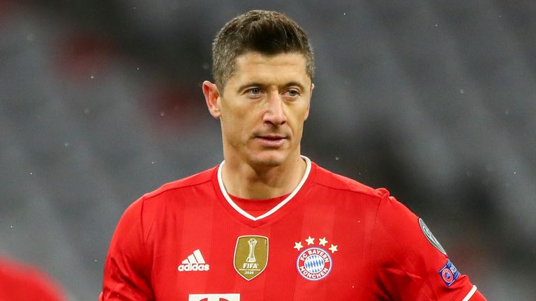 Bayern's Robert Lewandowski holds a ball before scoring from a penalty kick during the Champions League, round of 16, second leg soccer match between FC Bayern Munich and Lazio at the soccer Arena stadium in Munich, Germany, Wednesday, March 17, 2021. (AP Photo/Matthias Schrader)