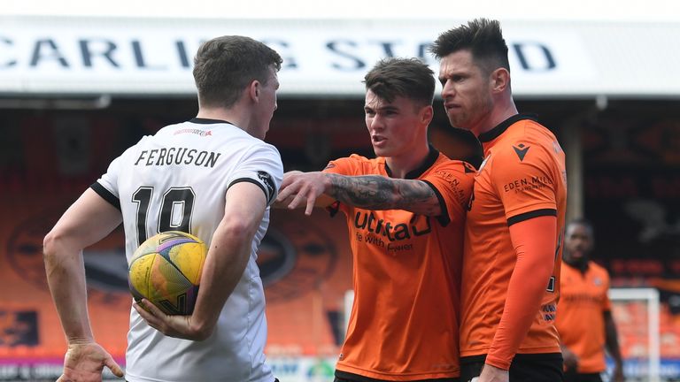 Aberdeen's Lewis Ferguson is confronted by Dundee United's Jamie Robson 