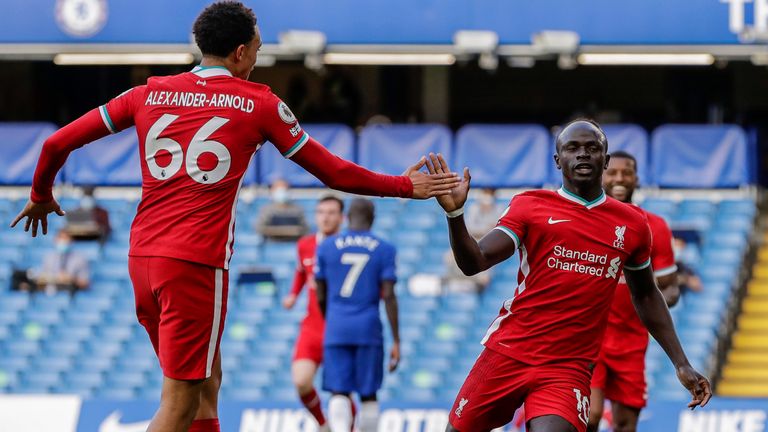 Liverpool's Sadio Mane is congratulated by Liverpool's Trent Alexander-Arnold after scoring during the English Premier League soccer match between Chelsea and Liverpool at Stamford Bridge Stadium, Sunday, Sept. 20, 2020. (AP Photo/Matt Dunham, Pool)