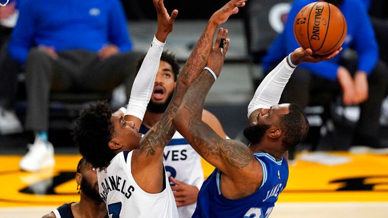 AP - Los Angeles Lakers forward LeBron James, right, shoots as Minnesota Timberwolves forward Jaden McDaniels,