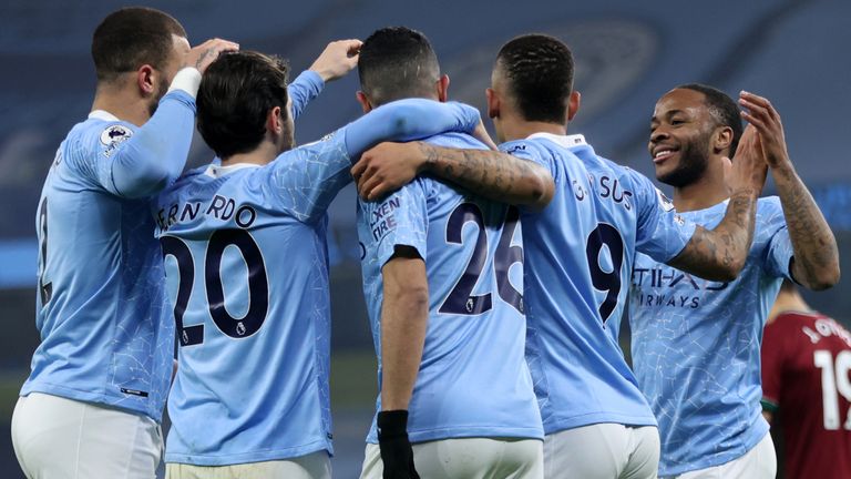Manchester City players celebrate taking the lead against Wolves