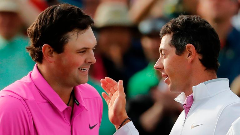 Patrick Reed, left, is congratulated by Rory McIlroy after winning the Masters golf tournament Sunday, April 8, 2018, 