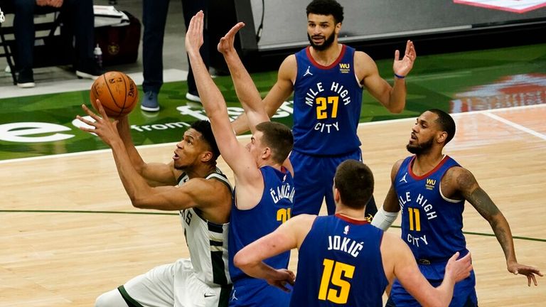 AP - Milwaukee Bucks' Giannis Antetokounmpo gets past Denver Nuggets' Vlatko Cancar 