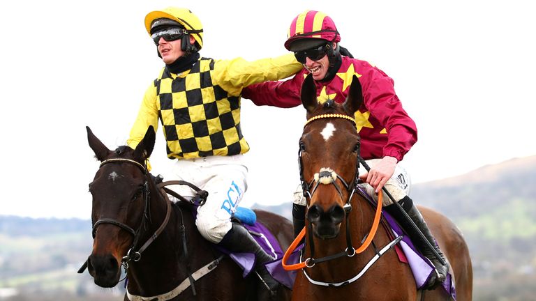 Jack Kennedy riding Minella Indo (right) is congratulated by Paul Townend on Al Boum Photo after winning the WellChild Cheltenham Gold Cup