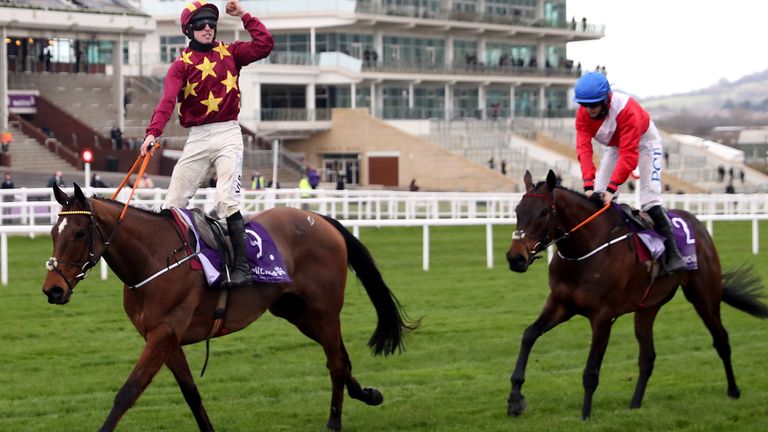 Jockey Jack Kennedy celebrates winning the WellChild Cheltenham Gold Cup Chase on Minella Indo ahead of A Plus Tard and Rachael Blackmore (right) during day four of the Cheltenham Festival