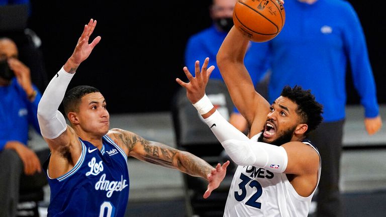 AP - Minnesota Timberwolves center Karl-Anthony Towns, right, shoots as Los Angeles Lakers forward Kyle Kuzma defends