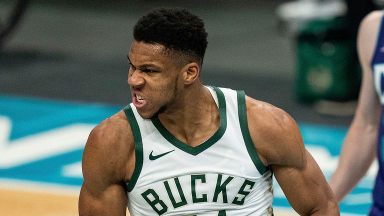 Milwaukee Bucks forward Giannis Antetokounmpo reacts after a dunk against the Charlotte Hornets during the second half of an NBA basketball game in Charlotte, N.C., Saturday, Jan. 30, 2021.