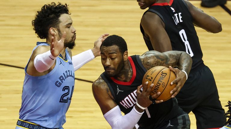 Houston Rockets guard John Wall (1) drives with the ball as Memphis Grizzlies guard Dillon Brooks (24) defends during the second quarter of an NBA basketball game Sunday, Feb. 28, 2021, in Houston.