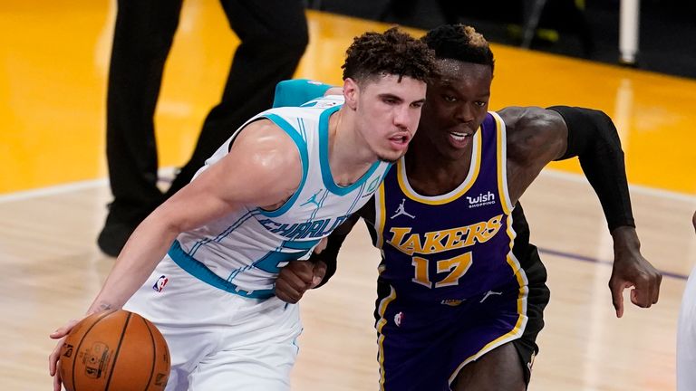 Charlotte Hornets guard LaMelo Ball, left, is defended by Los Angeles Lakers guard Dennis Schroder (17) during the first half of an NBA basketball game Thursday, March 18, 2021, in Los Angeles.