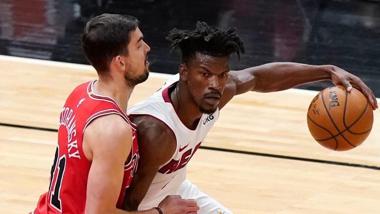 Miami Heat forward Jimmy Butler, right, drives against Chicago Bulls guard Tomas Satoransky during the first half of an NBA basketball game in Chicago, Friday, March 12, 2021. 