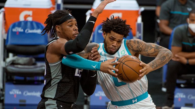 Sacramento Kings center Richaun Holmes defends against Charlotte Hornets forward Miles Bridges (0) during the first quarter of an NBA basketball game in Sacramento, Calif., Sunday, Feb. 28, 2021.