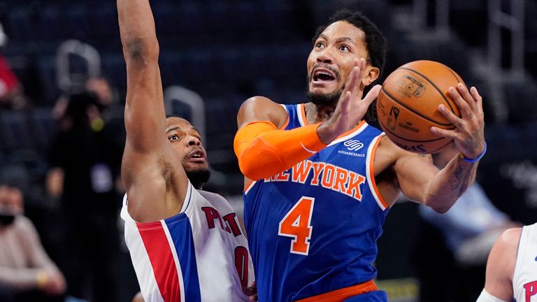 New York Knicks guard Derrick Rose (4) attempts a layup as Detroit Pistons guard Dennis Smith Jr. (0) defends during the first half of an NBA basketball game, Sunday, Feb. 28, 2021, in Detroit.