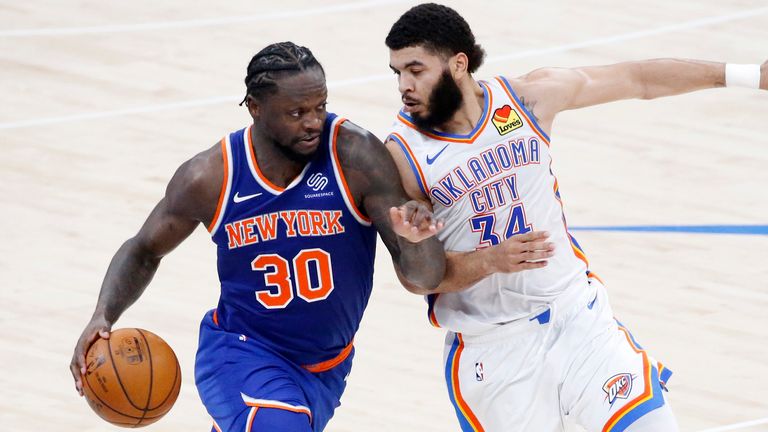 New York Knicks forward Julius Randle (30) goes against Oklahoma City Thunder guard Kenrich Williams (34) during the second half of an NBA basketball game, Saturday, March 13, 2021, in Oklahoma City.