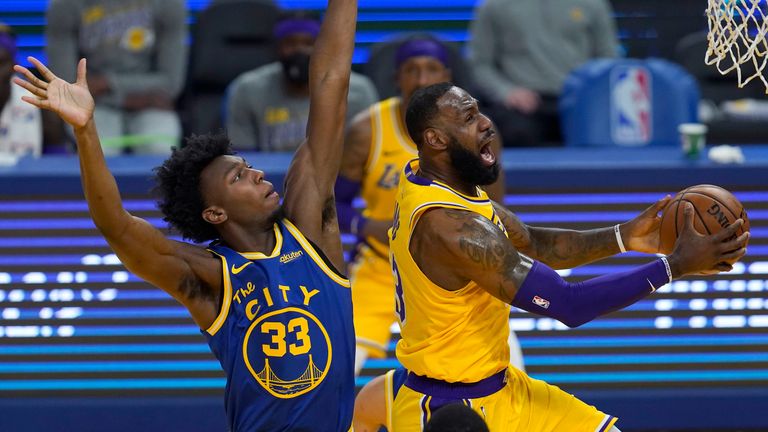 Los Angeles Lakers forward LeBron James, right, shoots against Golden State Warriors center James Wiseman (33) during the first half of an NBA basketball game in San Francisco, Monday, March 15, 2021.