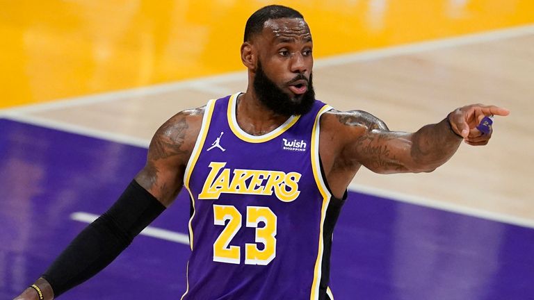 Los Angeles Lakers forward LeBron James signals to a teammate during the first half of an NBA basketball game against the Charlotte Hornets on Thursday, March 18, 2021, in Los Angeles. (