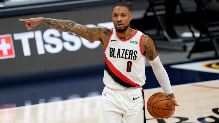 ortland Trail Blazers guard Damian Lillard directs his teammates against the Denver Nuggets in the second half of an NBA basketball game on Tuesday, Feb. 23, 2021, in Denver.