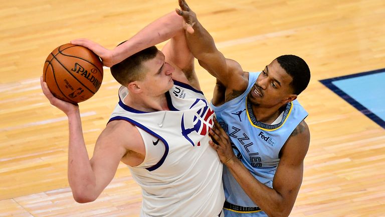 Denver Nuggets center Nikola Jokic handles the ball against Memphis Grizzlies guard De&#39;Anthony Melton in the second half of an NBA basketball game Friday, March 12, 2021, in Memphis, Tenn. 